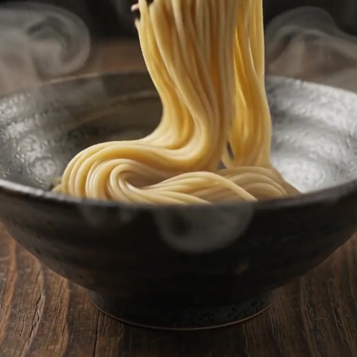 Noodles lowered into the bowl